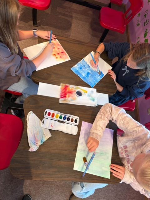 Kids painting with watercolors in art class